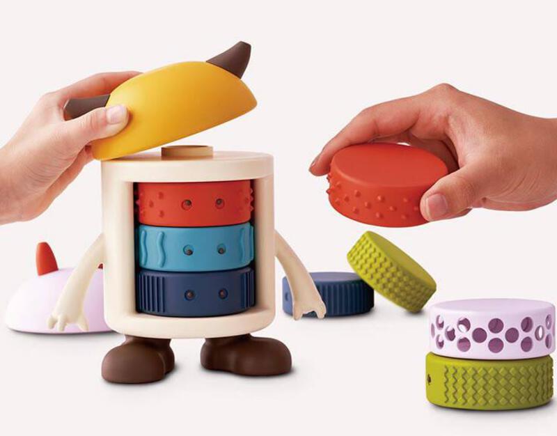 This may contain: two hands are playing with toys on a white surface and one is holding a banana