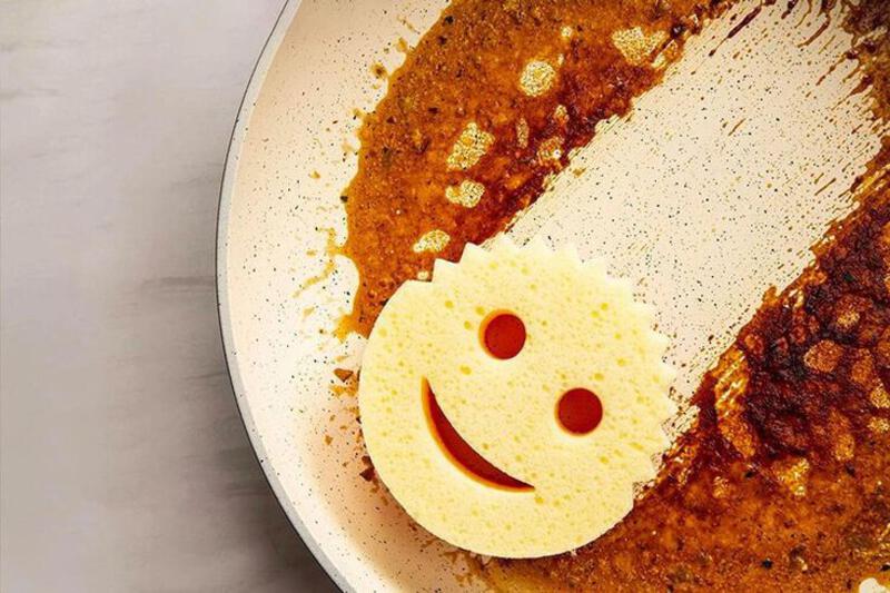 This may contain: a smiley face made out of bread on top of a white plate with brown spots