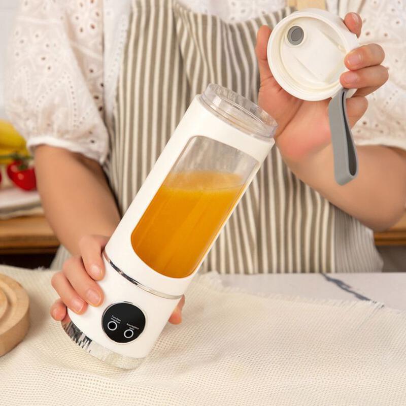This may contain: a woman is holding a blender with orange juice in it and the lid open