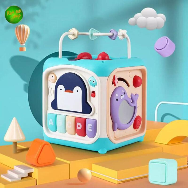 This may contain: a blue and white toy tv sitting on top of a wooden table next to other toys