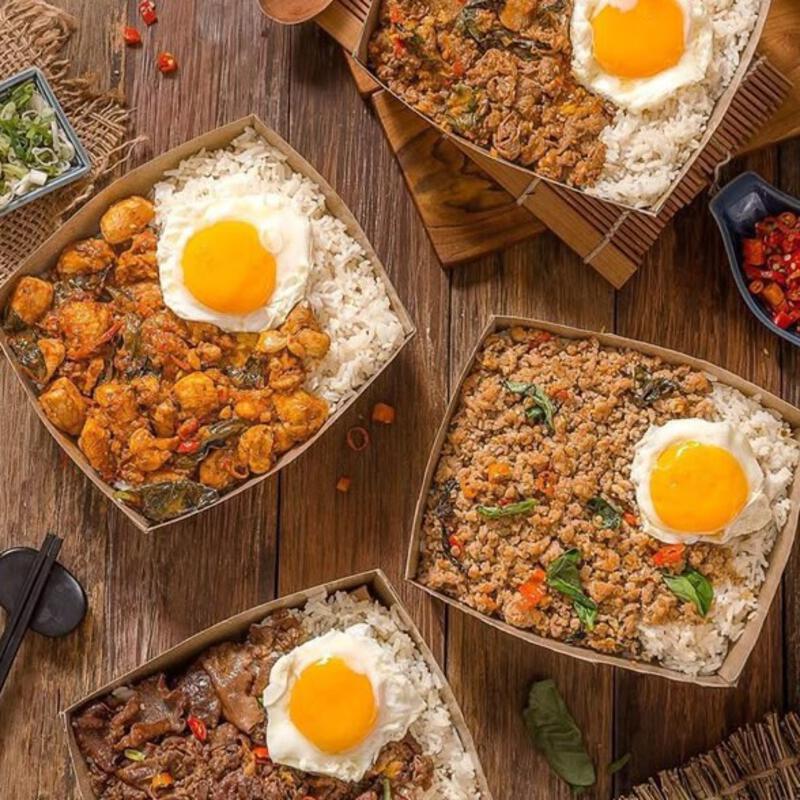 This may contain: three bowls filled with rice, meat and eggs on top of a wooden table next to utensils