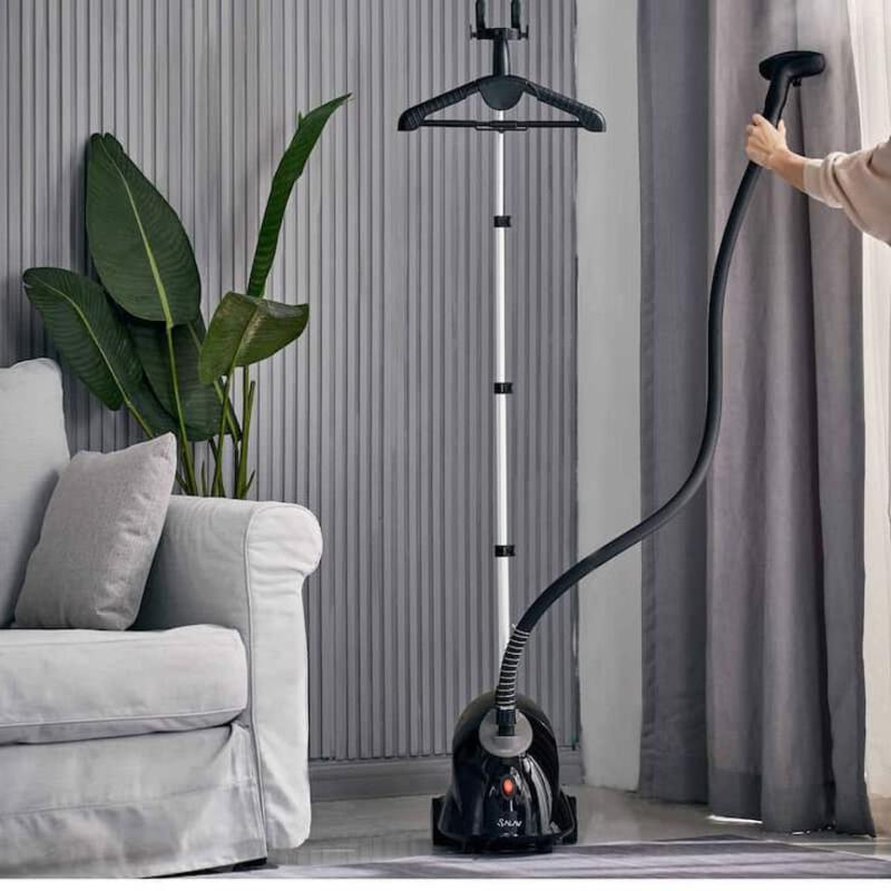 This may contain: a woman is vacuuming the floor in her living room with a large green plant