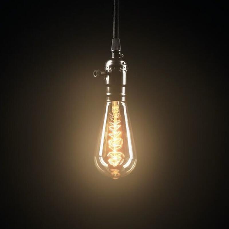 This may contain: a light bulb hanging from a wire in the dark