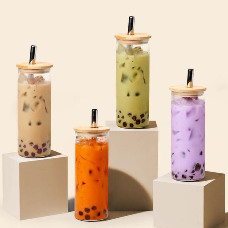 This may contain: four different colored drinks in small containers on top of each other with straws sticking out of them