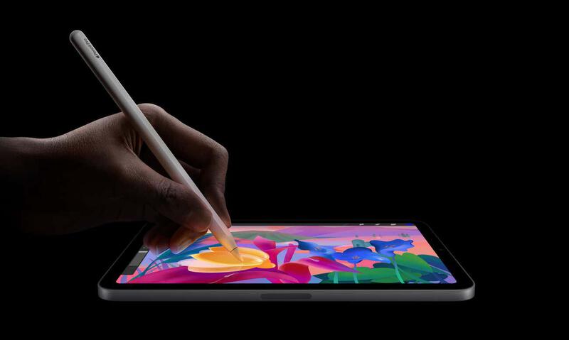 使用 Apple 第七代 iPad Mini(A17 Pro)并手持 Apple Pencil Pro。