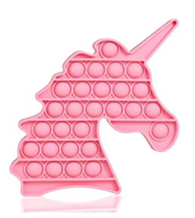This may contain: a pink unicorn shaped ice tray with circles on it