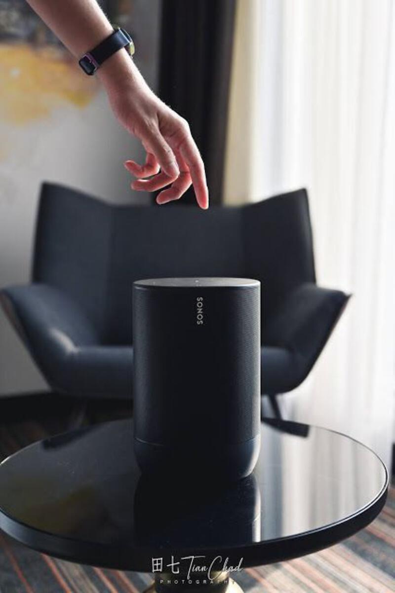 This may contain: a person reaching for an object on top of a table