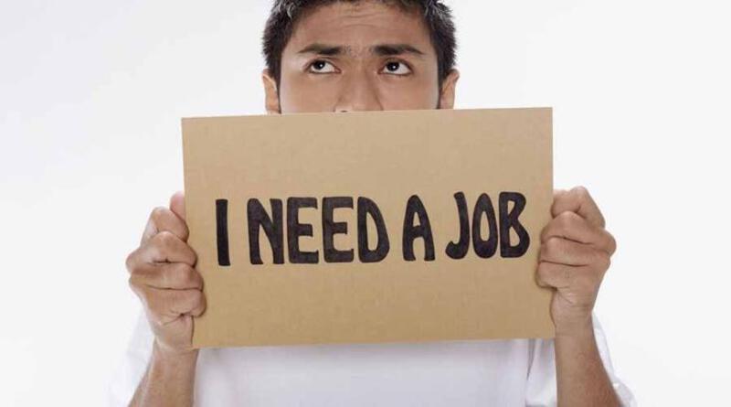 This may contain: a man holding up a cardboard sign with the words i need a job written on it