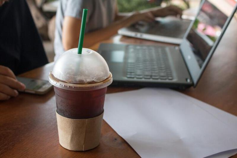 Iced coffee on wooden table business office work place concept | Premium Photo