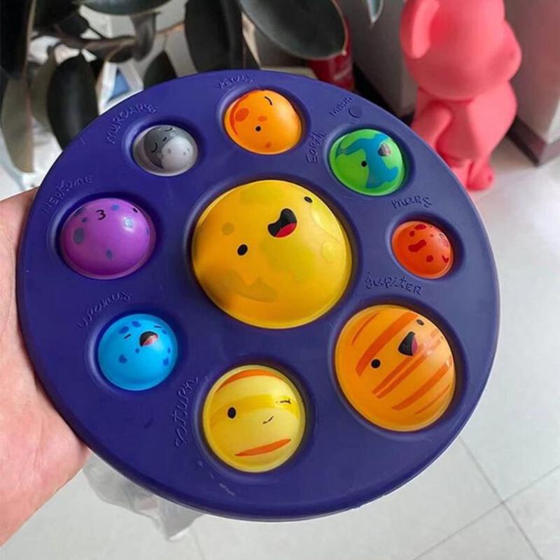 This may contain: a hand holding a toy with different colored faces on it