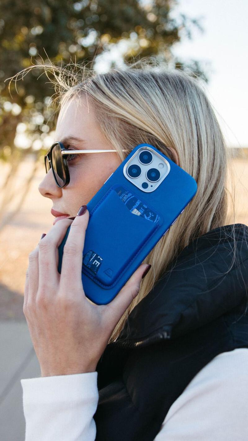 This may contain: a woman talking on her cell phone while wearing sunglasses