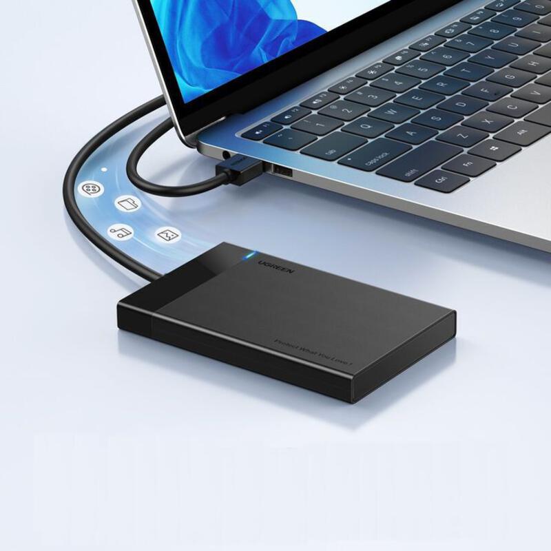 This may contain: an external hard drive connected to a laptop
