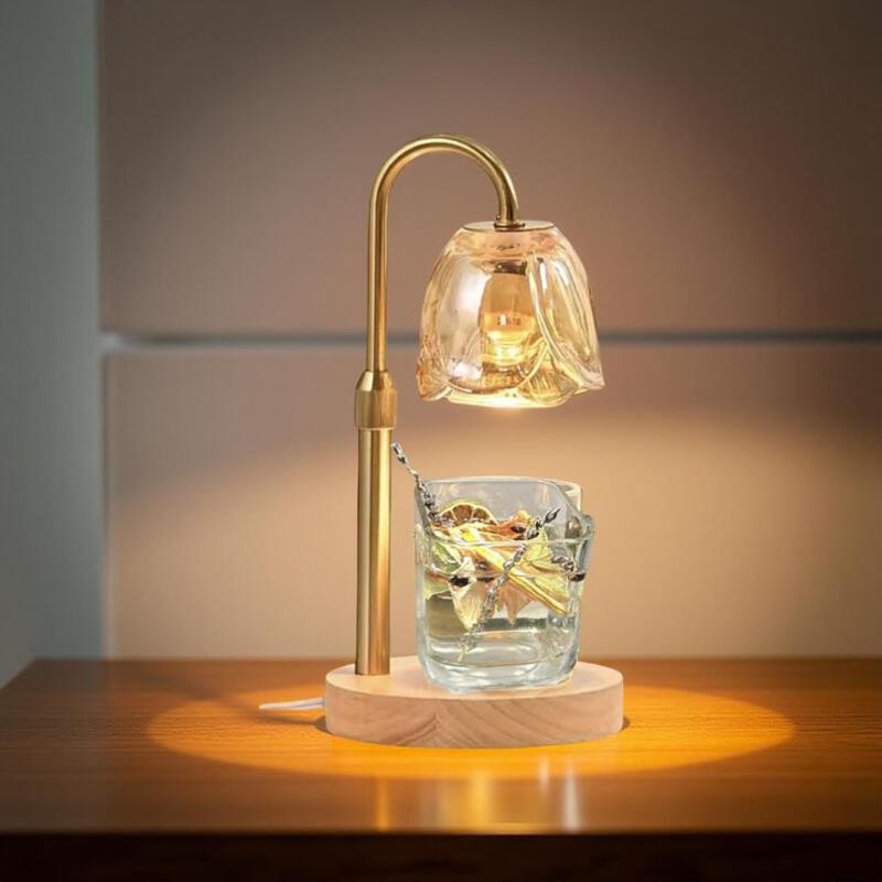 This may contain: a table lamp sitting on top of a wooden table next to a glass cup filled with water