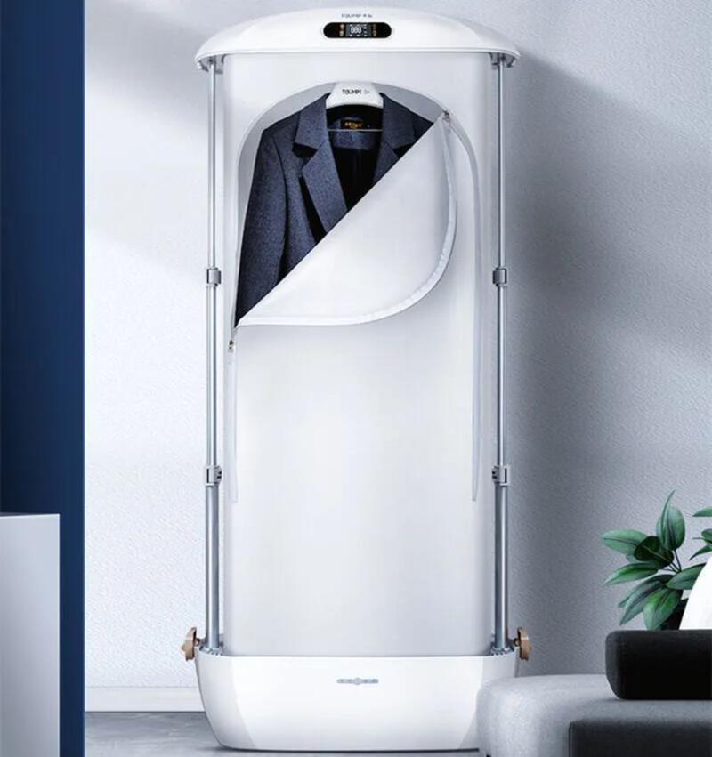 This may contain: a coat hanging on the wall in front of a white cabinet with an open door