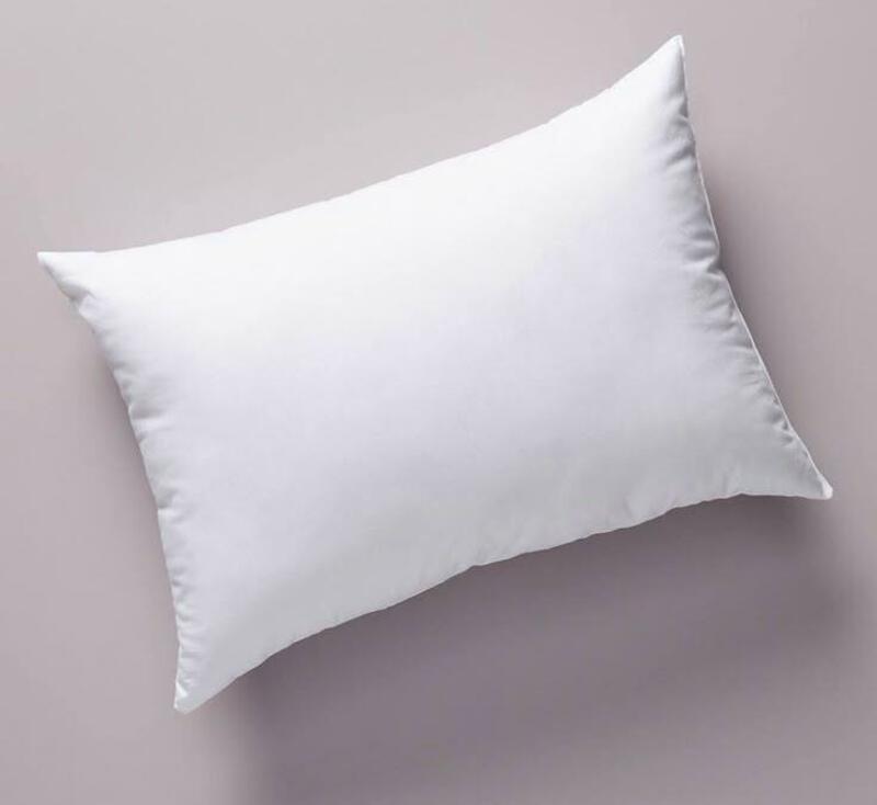 This may contain: a white pillow sitting on top of a purple wall