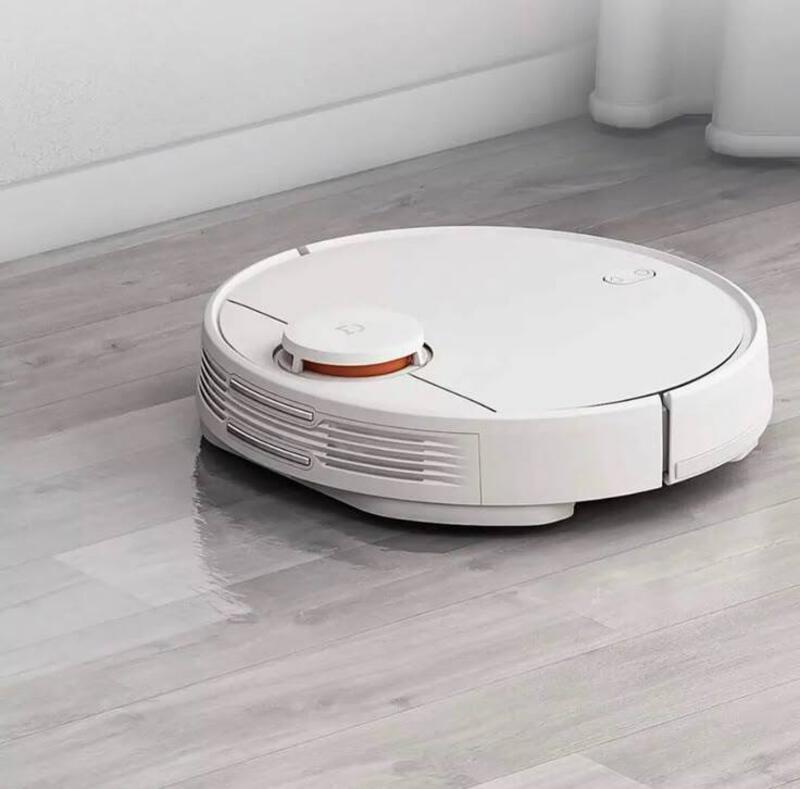 This may contain: a white robotic vacuum on the floor