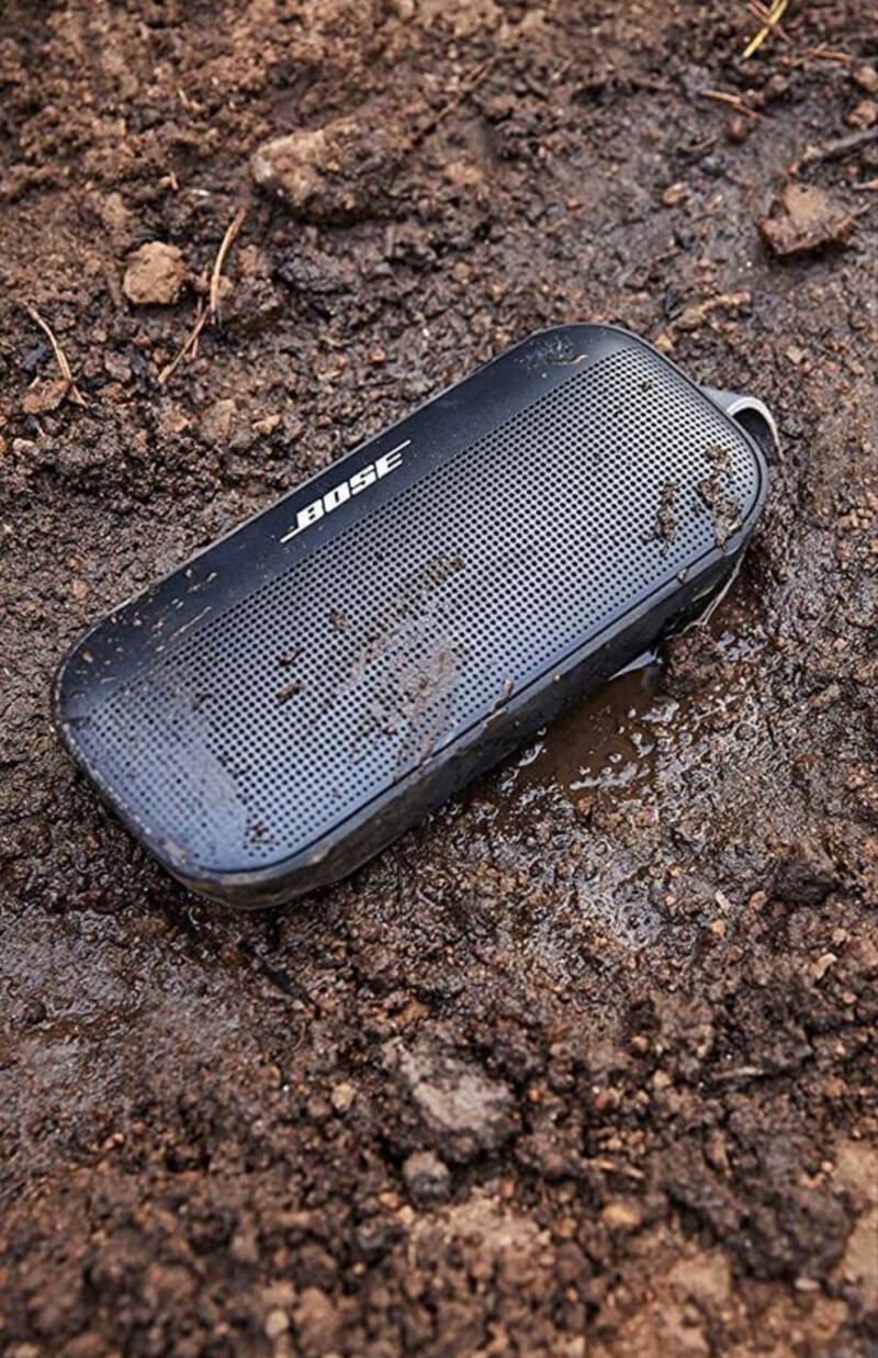 This may contain: an old cell phone laying on the ground in dirt and mud with water droplets all over it
