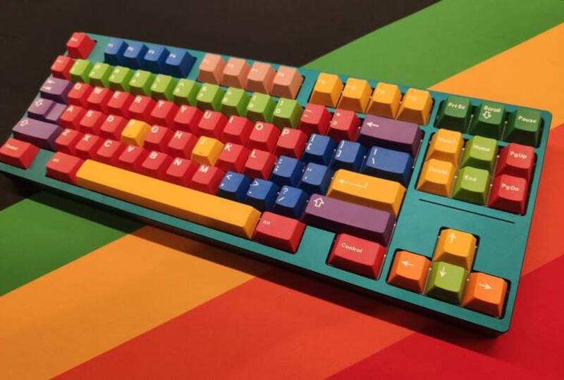 This may contain: a colorful keyboard sitting on top of a table