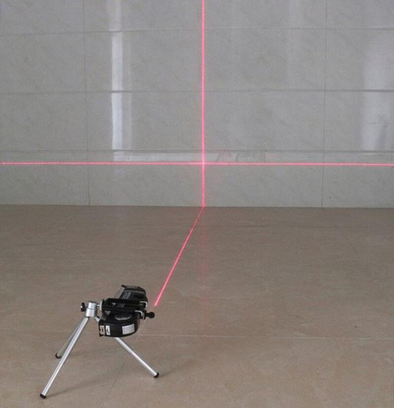 This may contain: a tripod with a red laser on it in front of a white wall and floor