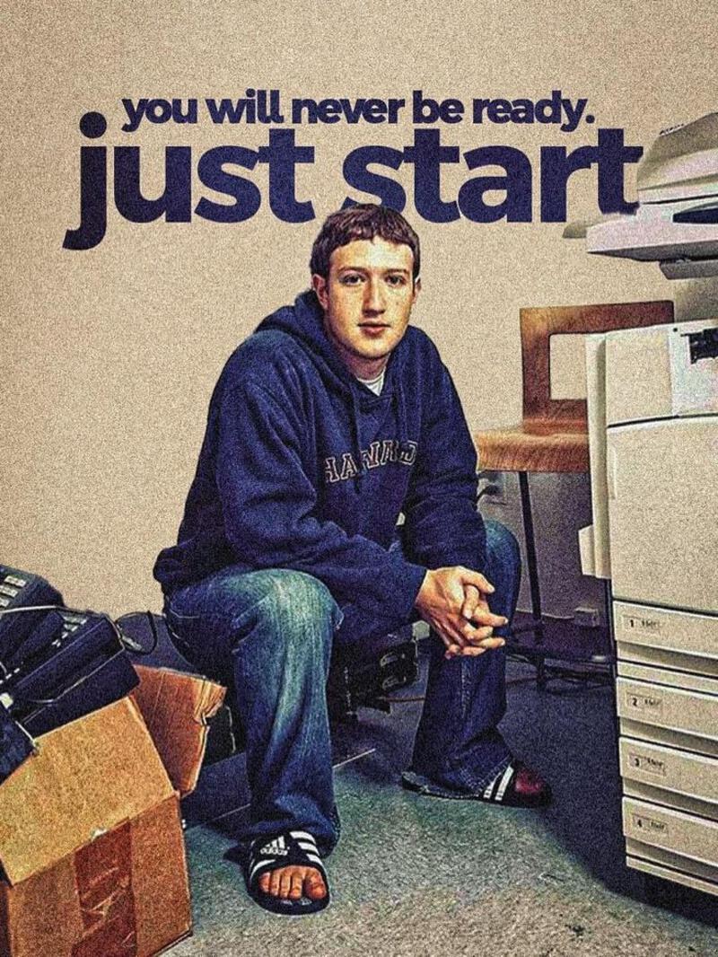 This may contain: a man sitting on the floor next to a pile of luggage in front of a poster