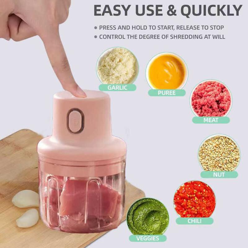 This may contain: a hand is pressing the button on an electric food processor with ingredients in front of it