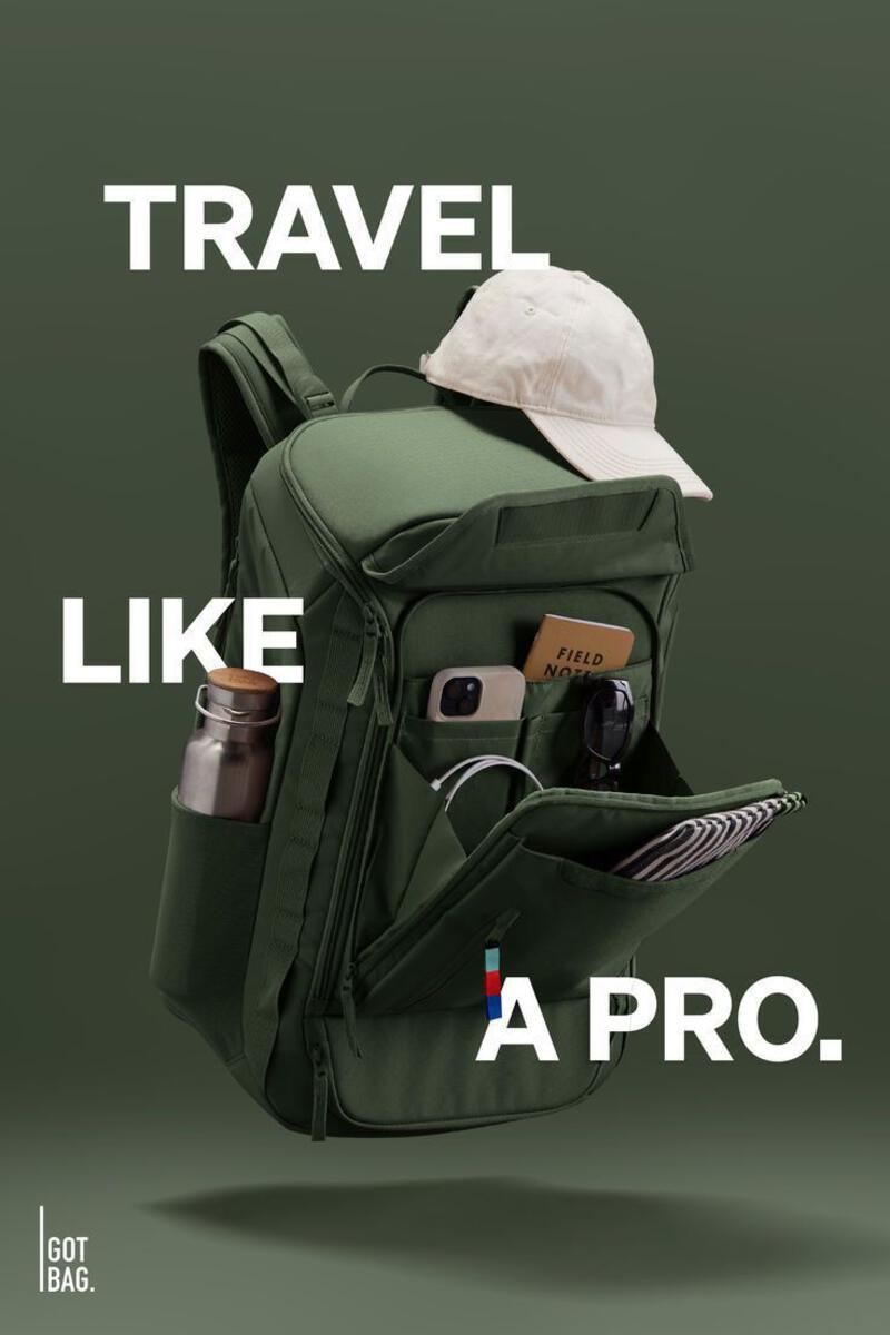 This may contain: a backpack with the words travel like a pro in front of it and an image of a hat on top