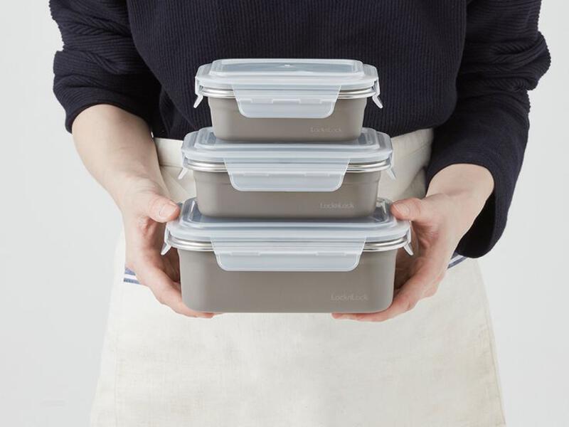 This may contain: a person holding three plastic containers in their hands