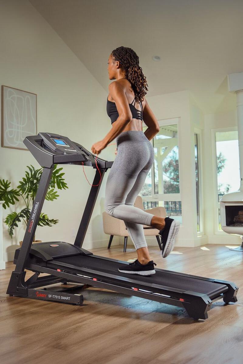 This may contain: a woman is running on a treadmill