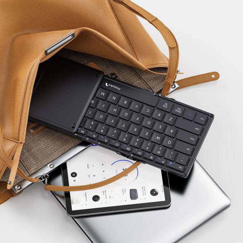 This may contain: a laptop, keyboard and purse sitting on top of each other next to an ipad
