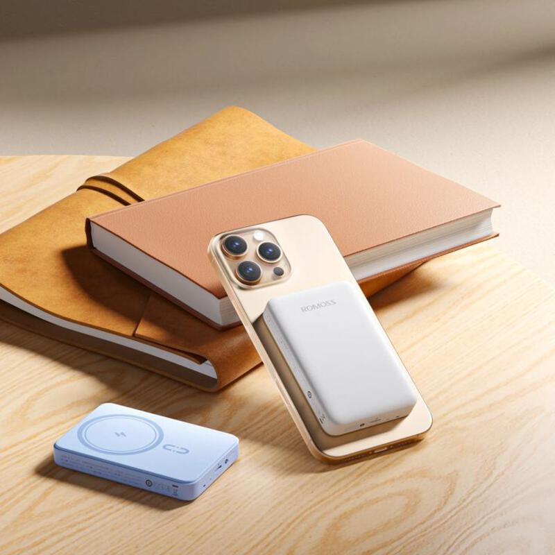 This may contain: an iphone is sitting on a table next to some books and a book with a phone in it